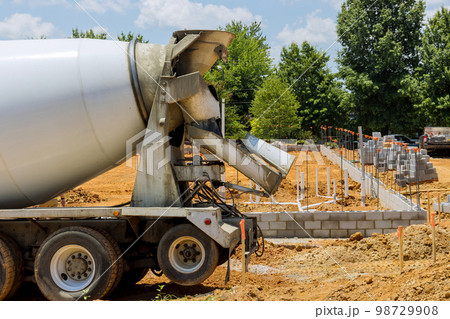 In preparation for pouring concrete columns from concrete mix car at construction site are formed In preparation for pouring concrete columns from concrete mix car at construction site are formed 98729908