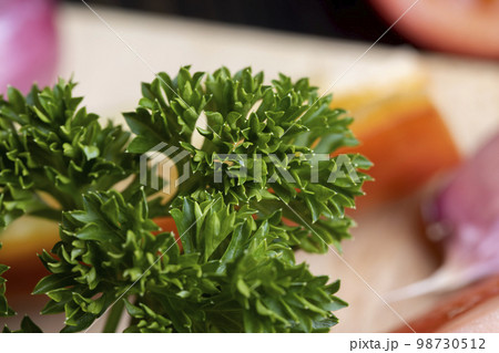 Clean washed parsley on the table during cooking 98730512