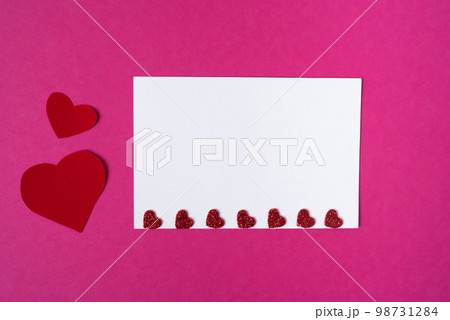 Red hearts on a white sheet. Mockup for a postcard. Valentine's day concept. Copy space 98731284