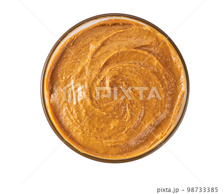 Bowl of peanut butter isolated on white background, top view. 98733385