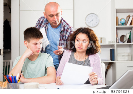 Family with son working with papers Family with son working with papers 98734823