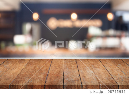 Perspective top wooden with blurred cafe background Perspective top wooden with blurred cafe background 98735953