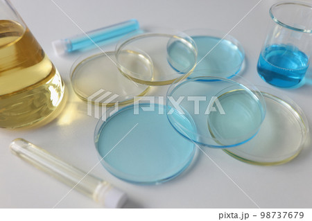 Laboratory glassware with colored liquids on lab table close up. Laboratory glassware with colored liquids on lab table close up. 98737679