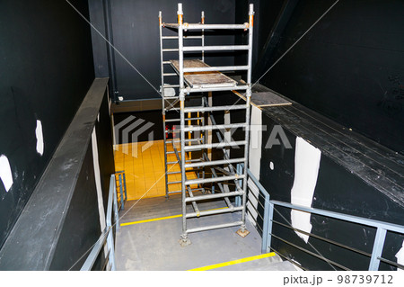 Cosmetic repair of the stairwell walls using modern metallic tubular multilevel scaffolding Cosmetic repair of the stairwell walls using modern metallic tubular multilevel scaffolding 98739712