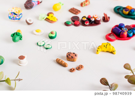 Bread, baguette, pretzels and other polymer clay food on a light background. Children's leisure. 98740939