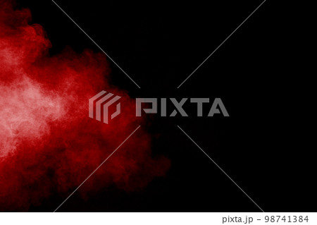 Red powder explosion cloud on black background. Freeze motion of red color dust particles splashing. Red powder explosion cloud on black background. Freeze motion of red color dust particles splashing. 98741384