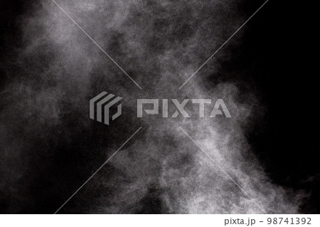White dust cloud in the air.Abstract white powder explosion against black background. 98741392
