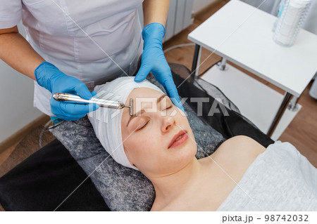Beautiful woman is undergoing a course of spa treatments in spa salon. 98742032