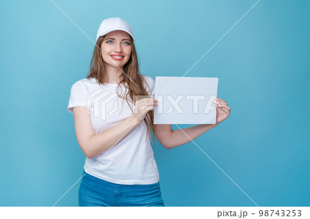 Beautiful young woman holding blank white paper board, your text here concept Beautiful young woman holding blank white paper board, your text here concept 98743253