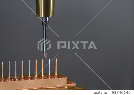 Close up scene the CNC milling machine cutting the copper electrode parts with solid ball end mill. Close up scene the CNC milling machine cutting the copper electrode parts with solid ball end mill. 98746140