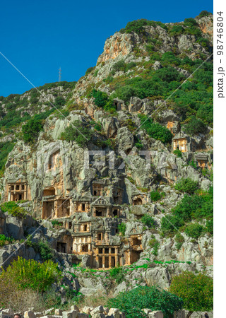 Ruins of Rock-cut tombs in ancient Lycian city of Myra. Lycian way, Demre, Antalya province, Turkey. 98746804