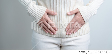 Woman holding her belly. Pregnancy, Reproductive system, menstruation, and gynecology concept Woman holding her belly. Pregnancy, Reproductive system, menstruation, and gynecology concept 98747749
