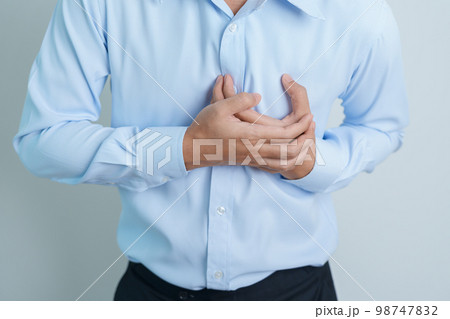 man hand holding chest ache. Heart disease, angina disease and symptom heart attack disease Cardiovascular, Atherosclerosis, Hypertensive world Heart day and health concept 98747832