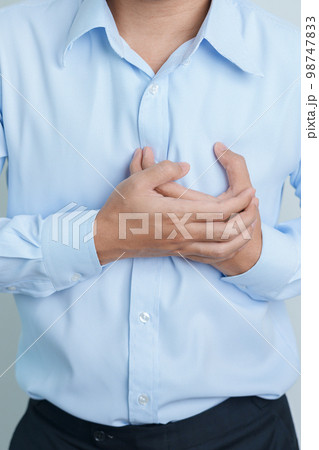 man hand holding chest ache. Heart disease, angina disease and symptom heart attack disease Cardiovascular, Atherosclerosis, Hypertensive world Heart day and health concept 98747833