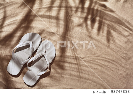 Traveler vacation accessories are laid out on a white beach sand. Flat lay, top view. 98747858