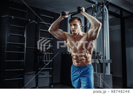 Sexy muscular man posing in gym, shaped abdominal. Strong male naked torso abs, working out 98748249