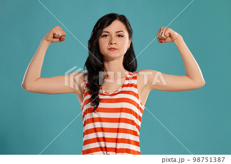 Studio photo of a gorgeous girl teenager posing over a blue background. 98751387