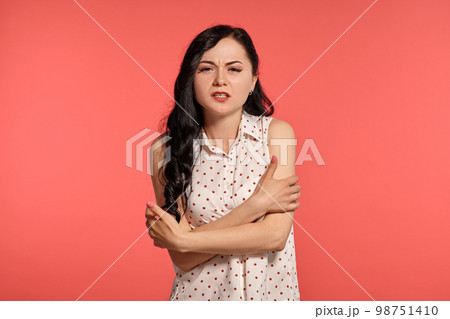 Studio shot of a lovely girl teenager posing over a pink background. 98751410