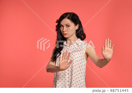 Studio shot of a lovely girl teenager posing over a pink background. 98751445