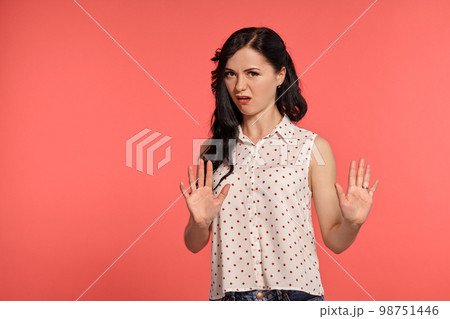 Studio shot of a lovely girl teenager posing over a pink background. Studio shot of a lovely girl teenager posing over a pink background. 98751446