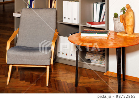 A comfortable armchair near the coffee table in the reading room of the old library. 98752865