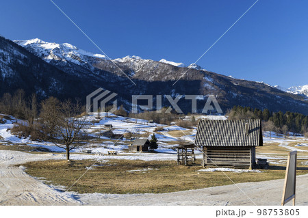 Typical landscape with wooden log cabins near Bohinjska Bistrica, Triglavski national park, Slovenia 98753805