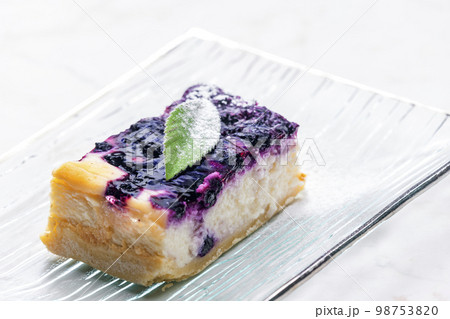 a piece of blueberry cheesecake on the glass plate 98753820