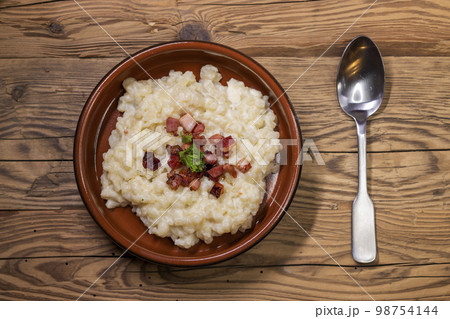 Slovakian halusky served with sheep cheese and roasted bacon Slovakian halusky served with sheep cheese and roasted bacon 98754144