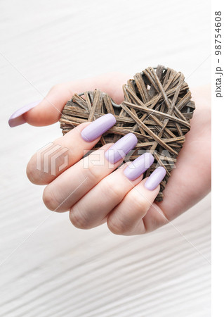 Girl's hands with delicate purple manicure and decoratine heart 98754608