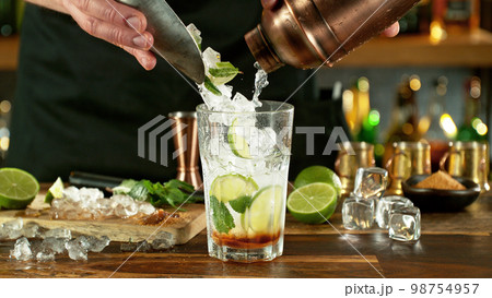 Preparation of mojito drink on bar counter. Preparation of mojito drink on bar counter. 98754957