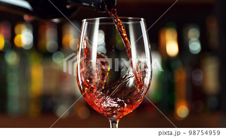 Detail of pouring red wine into glass. Detail of pouring red wine into glass. 98754959