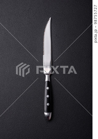 Metal kitchen knife on a dark textured concrete background 98755727