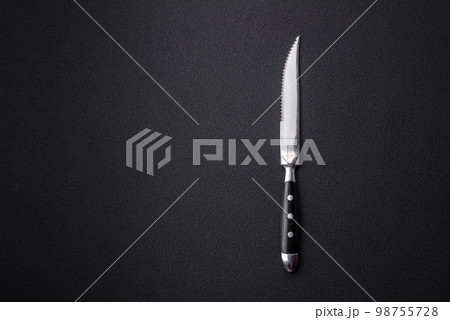Metal kitchen knife on a dark textured concrete background 98755728