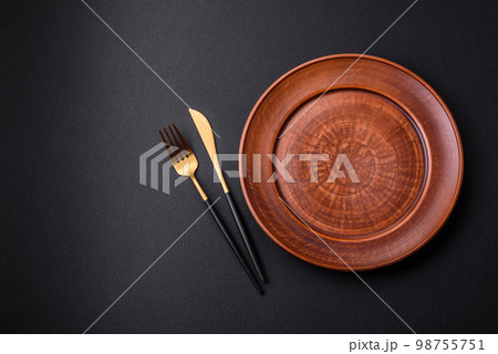 Empty ceramic round plate on dark textured concrete background 98755751