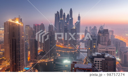View of various skyscrapers in tallest recidential block in Dubai Marina aerial night to day View of various skyscrapers in tallest recidential block in Dubai Marina aerial night to day 98757274