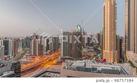 Skyscrapers at the Business Bay in Dubai aerial night to day , United Arab Emirates Skyscrapers at the Business Bay in Dubai aerial night to day , United Arab Emirates 98757384