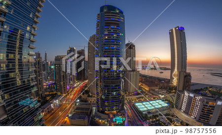 Panorama of the Dubai Marina and JBR area and the famous Ferris Wheel aerial day to night Panorama of the Dubai Marina and JBR area and the famous Ferris Wheel aerial day to night 98757556