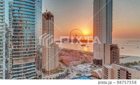 Panoramic sunset view of the Dubai Marina and JBR area and the famous Ferris Wheel aerial 98757558