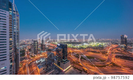 Aerial view of media city and al barsha heights district area day to night from Dubai marina. Aerial view of media city and al barsha heights district area day to night from Dubai marina. 98757592