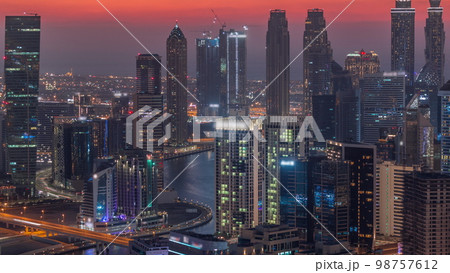 Skyline with modern architecture of Dubai business bay towers day to night . Aerial view Skyline with modern architecture of Dubai business bay towers day to night . Aerial view 98757612