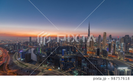 Skyline with modern architecture of Dubai business bay towers day to night . Aerial view Skyline with modern architecture of Dubai business bay towers day to night . Aerial view 98757618
