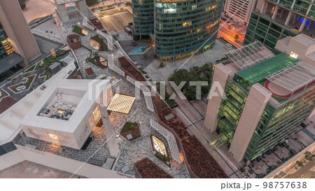 Dubai international financial center skyscrapers aerial night to day . Dubai international financial center skyscrapers aerial night to day . 98757638