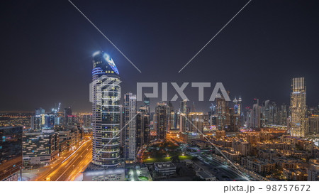 Panorama showing Dubai's business bay towers aerial night . Rooftop view of some skyscrapers Panorama showing Dubai's business bay towers aerial night . Rooftop view of some skyscrapers 98757672
