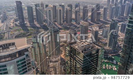JLT and Dubai Marina skyscrapers intersected by Sheikh Zayed Road all day JLT and Dubai Marina skyscrapers intersected by Sheikh Zayed Road all day 98757729