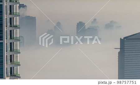 Dubai Aerial view showing fog over al barsha heights and greens district area Dubai Aerial view showing fog over al barsha heights and greens district area 98757751