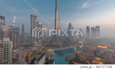Aerial view of Dubai city early morning during fog night to day . Aerial view of Dubai city early morning during fog night to day . 98757788