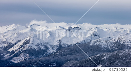 Snow and Cloud covered Canadian Nature Landscape Background. Winter Season in Whistler Snow and Cloud covered Canadian Nature Landscape Background. Winter Season in Whistler 98759525