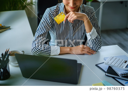 Woman using shopping web site by laptop computer and payment by credit card. Woman using shopping web site by laptop computer and payment by credit card. 98760375