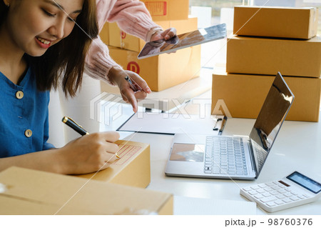 Asian small business owner working together with friend at home office. Business retail market and online sell marketing delivery, SME e-commerce concept. 98760376