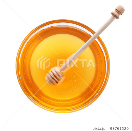 Bowl of organic honey and dipper isolated on white, top view 98761520